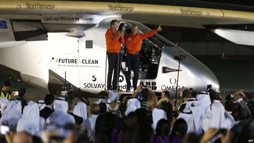 Bertrand Piccard (R) and Andre Borschberg (L), pilots of the solar powered Solar Impulse 2 aircraft, are greeted upon arrival at Al Batin Airport in Abu Dabi to complete its world tour flight on July 26, 2016, in the United Arab Emirates.