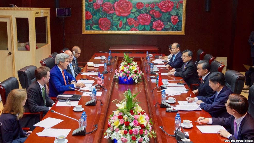 U.S. Secretary of State John Kerry (left) addresses Chinese Foreign Minister Wang Yi and his delegation at the National Convention Center in Vientiane, Laos, on July 25, 2016.